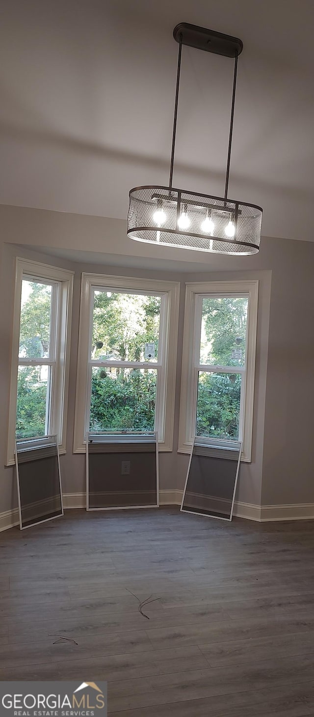 interior space with dark hardwood / wood-style flooring and a healthy amount of sunlight