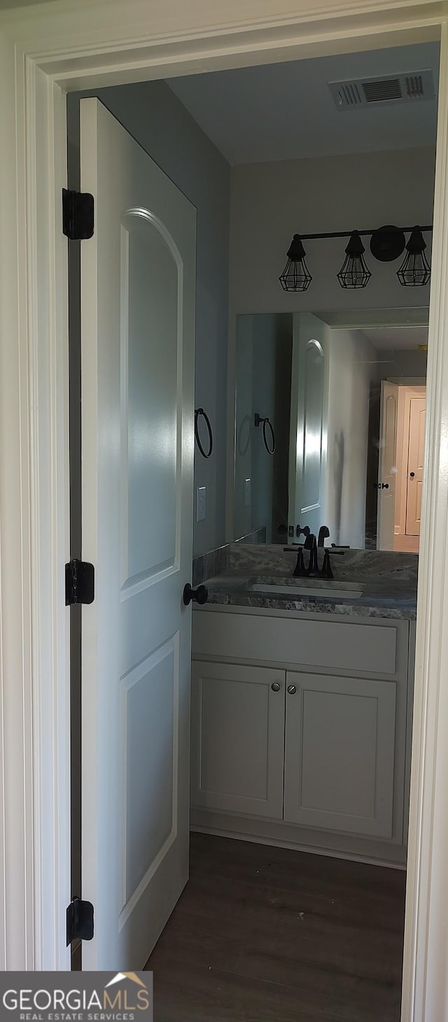 bathroom featuring vanity and hardwood / wood-style flooring