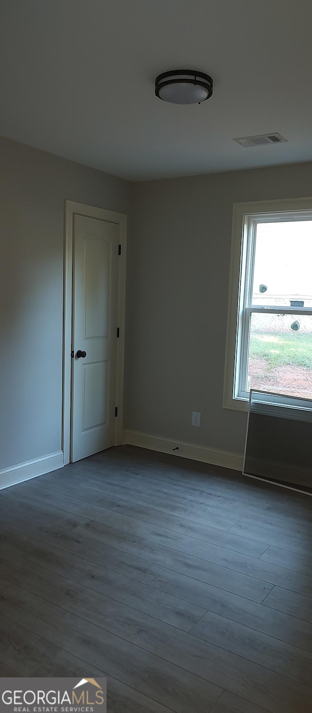 empty room with wood-type flooring