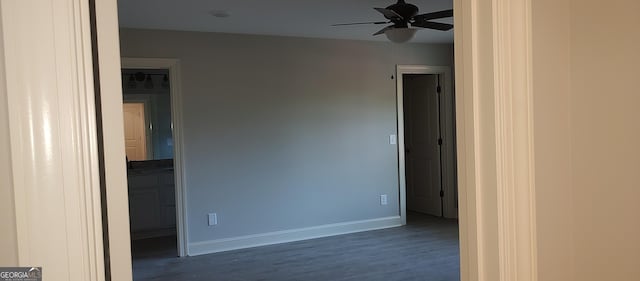 spare room with ceiling fan and dark hardwood / wood-style floors