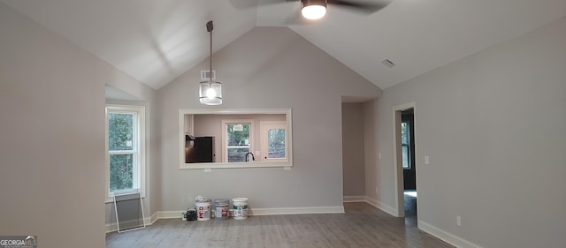 empty room featuring ceiling fan, wood-type flooring, and vaulted ceiling