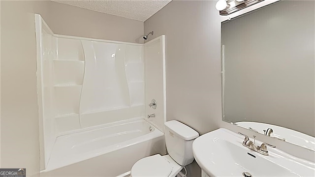 full bathroom featuring sink, a textured ceiling, shower / bathing tub combination, and toilet