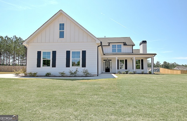 modern inspired farmhouse with covered porch and a front lawn