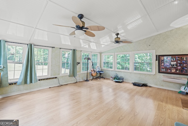 exercise room with light wood-type flooring, ceiling fan, and plenty of natural light