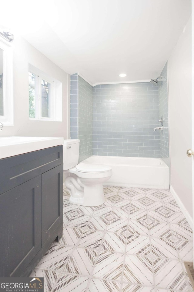 full bathroom featuring toilet, vanity, and tiled shower / bath combo