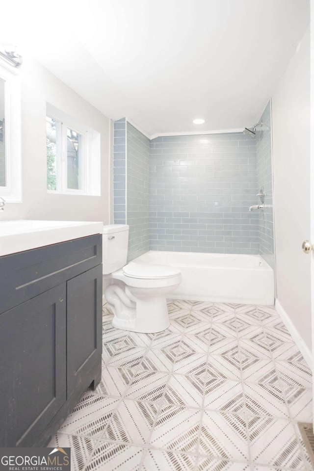 full bathroom featuring tile patterned flooring, shower / bathtub combination, toilet, and vanity