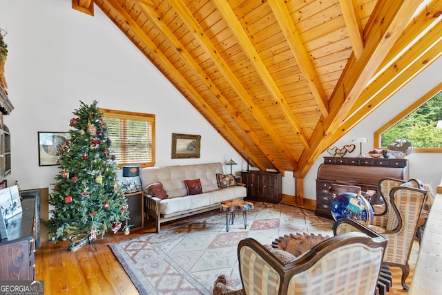 living room with vaulted ceiling with beams, wooden ceiling, and light wood-type flooring