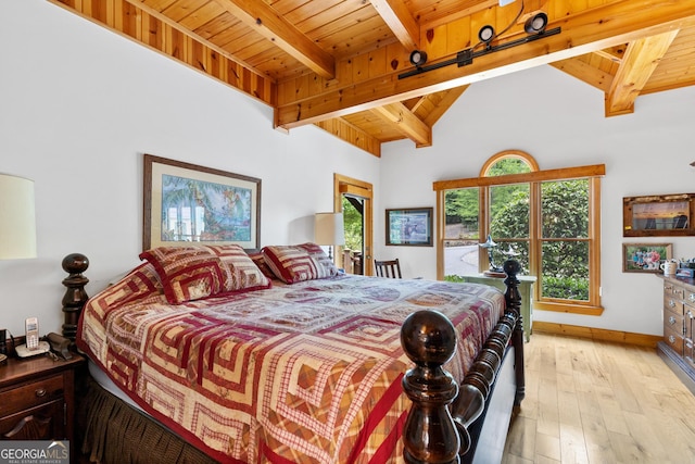 bedroom with lofted ceiling with beams, wooden ceiling, and light hardwood / wood-style floors