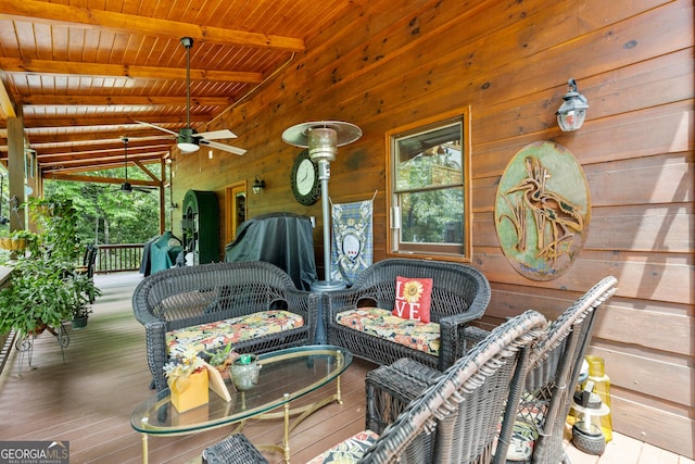 wooden deck featuring covered porch and ceiling fan