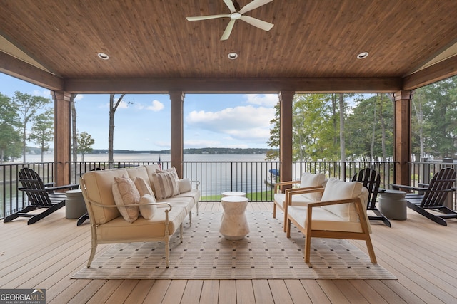 sunroom / solarium with lofted ceiling, a water view, ceiling fan, and wooden ceiling