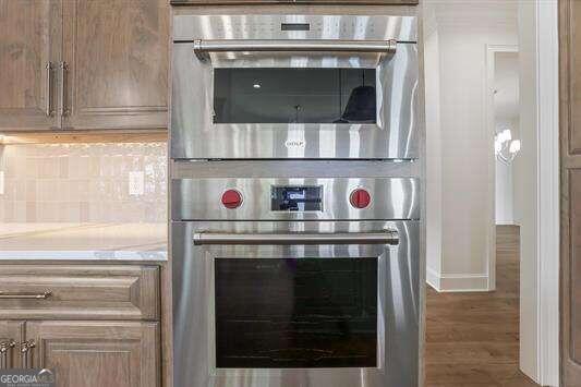 kitchen featuring dark wood-type flooring and tasteful backsplash