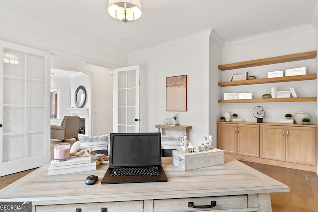 office space featuring light hardwood / wood-style floors, ornamental molding, and french doors