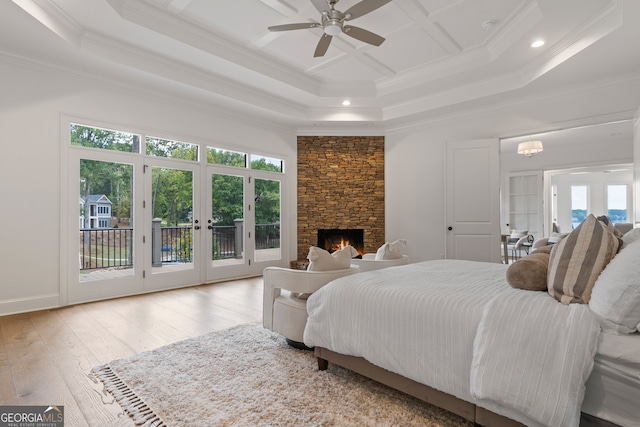 bedroom with multiple windows, crown molding, light hardwood / wood-style flooring, and french doors