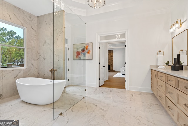 bathroom with vanity, tile walls, crown molding, and separate shower and tub