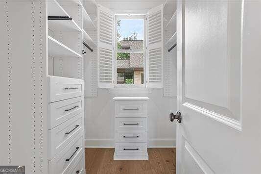 spacious closet featuring hardwood / wood-style floors