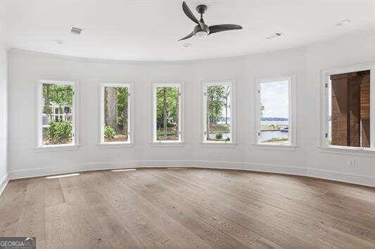 unfurnished sunroom with ceiling fan