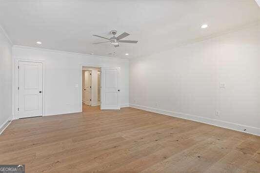 unfurnished room with ceiling fan, light hardwood / wood-style flooring, and ornamental molding