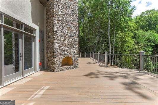 deck featuring an outdoor stone fireplace