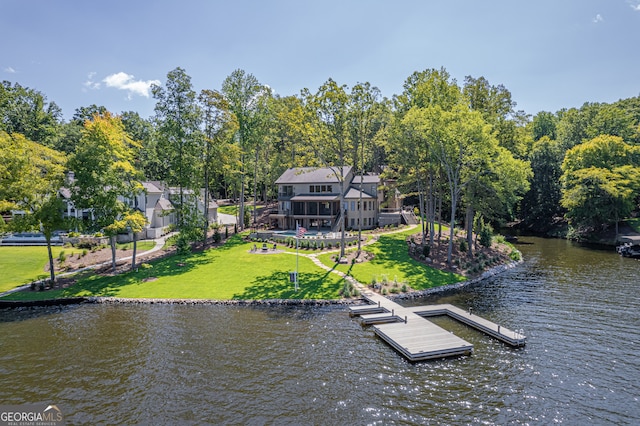 view of dock featuring a water view and a yard