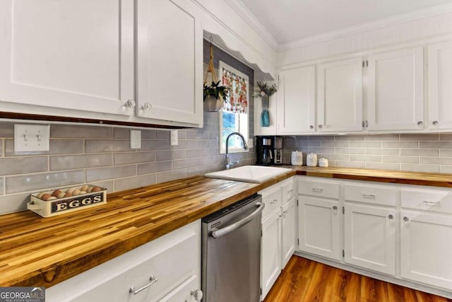 kitchen featuring wood counters, sink, white cabinetry, and stainless steel dishwasher