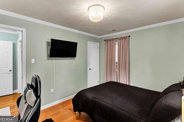 bedroom with crown molding and wood-type flooring