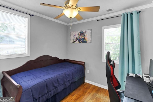 bedroom featuring crown molding, ceiling fan, and light hardwood / wood-style floors