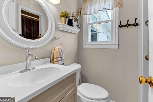 bathroom featuring vanity and toilet