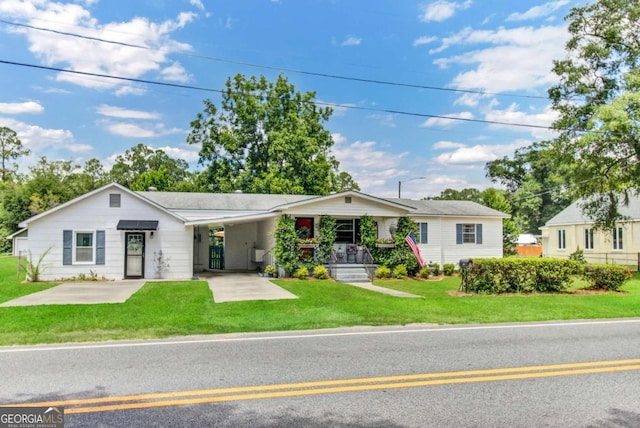 ranch-style house with a carport and a front lawn