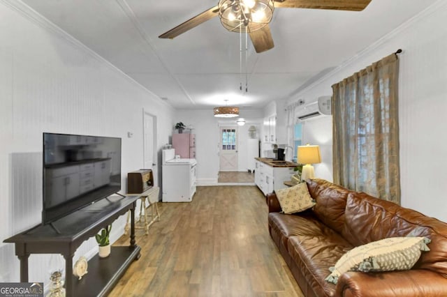 living room featuring hardwood / wood-style flooring, crown molding, a wall mounted air conditioner, and ceiling fan