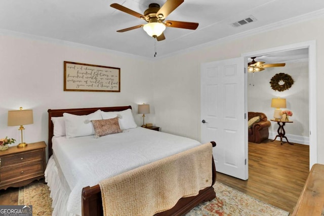 bedroom featuring crown molding, ceiling fan, and light hardwood / wood-style flooring