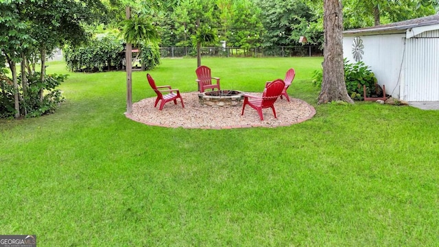 view of yard with a fire pit