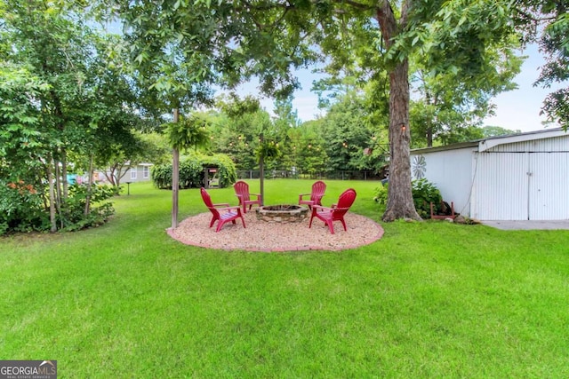 view of yard with an outdoor fire pit