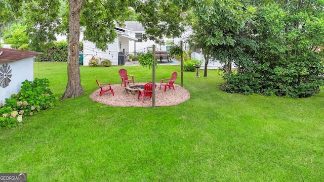 view of yard with an outdoor fire pit