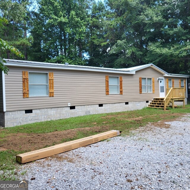 view of property exterior featuring crawl space and metal roof