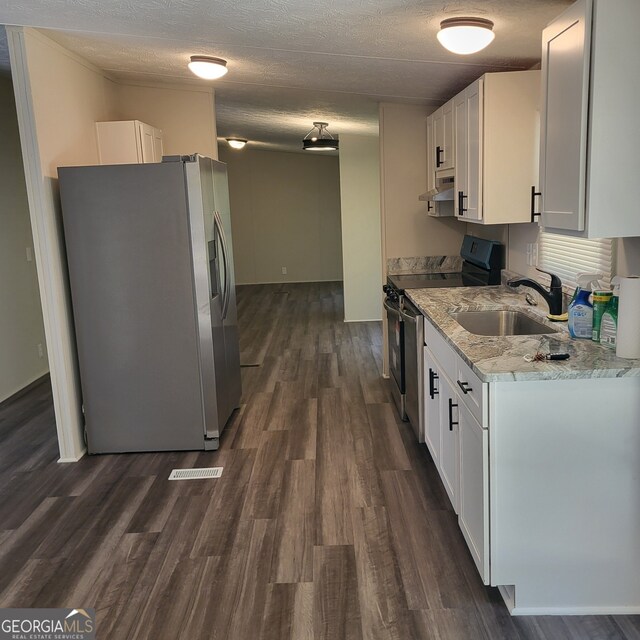 kitchen with black range with electric cooktop, a sink, white cabinetry, and stainless steel fridge with ice dispenser