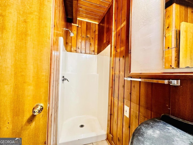 bathroom featuring wood ceiling, wooden walls, and a shower