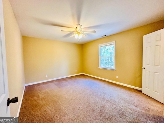 carpeted empty room featuring ceiling fan