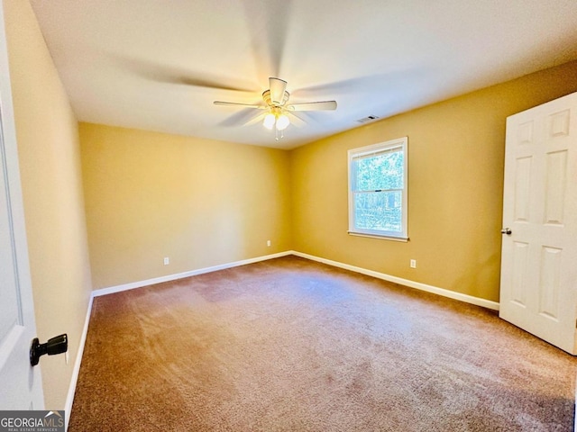 empty room with carpet flooring and ceiling fan