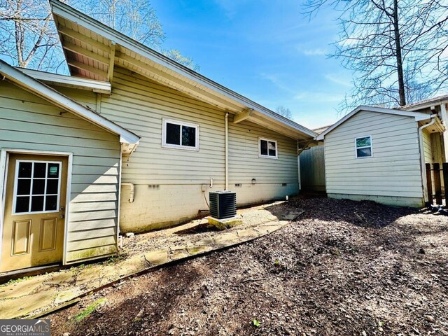 rear view of property featuring cooling unit