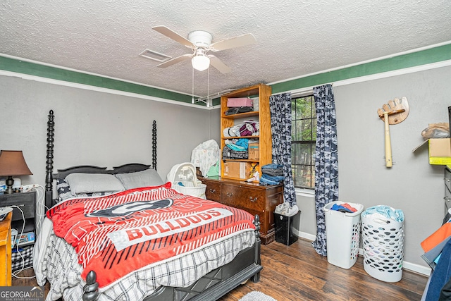 bedroom featuring ceiling fan, dark hardwood / wood-style floors, and a textured ceiling