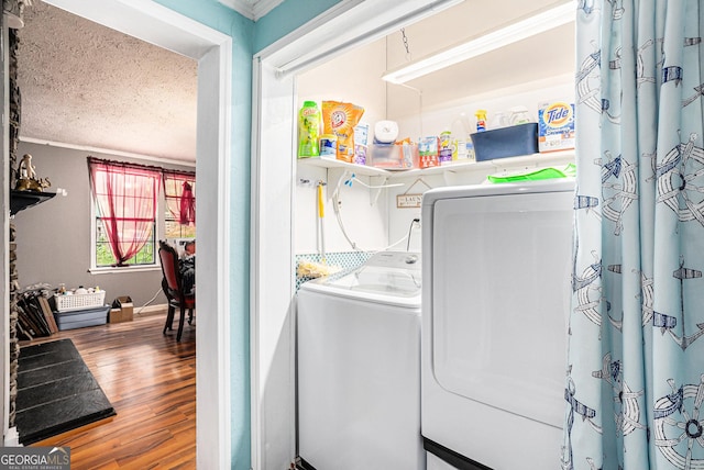 laundry area with hardwood / wood-style flooring, separate washer and dryer, and a textured ceiling