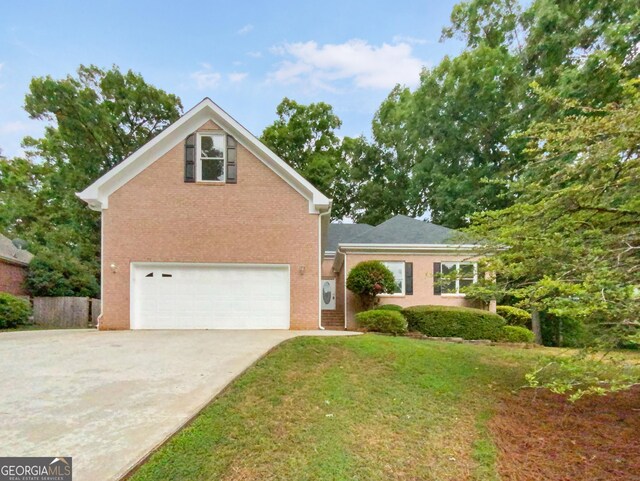 view of property featuring a garage and a front yard