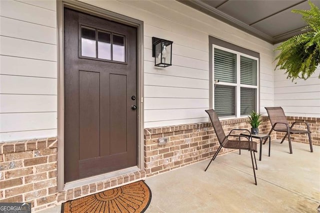 view of exterior entry with covered porch