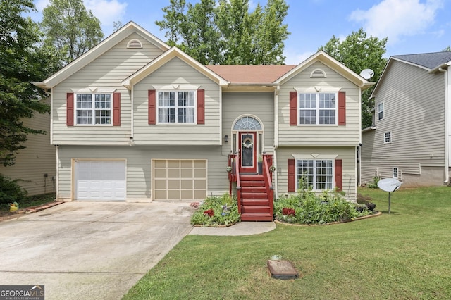 bi-level home featuring a garage and a front lawn