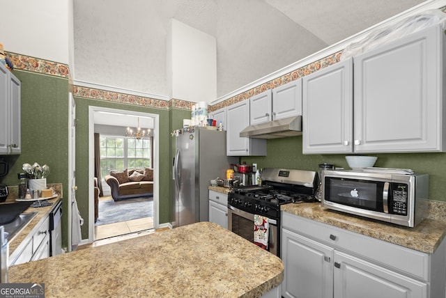 kitchen with white cabinets, stainless steel appliances, and a notable chandelier