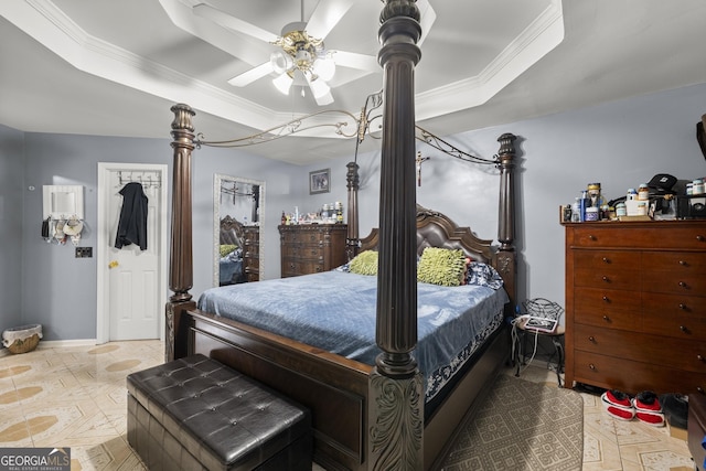 bedroom featuring ceiling fan, a tray ceiling, ornamental molding, and parquet floors