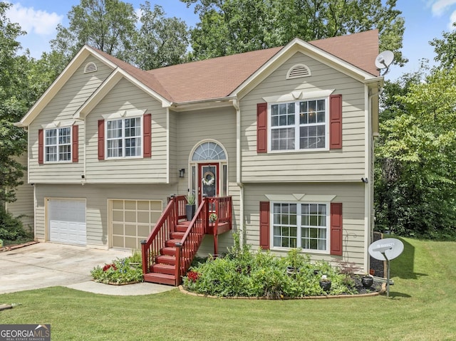 bi-level home with a garage and a front yard