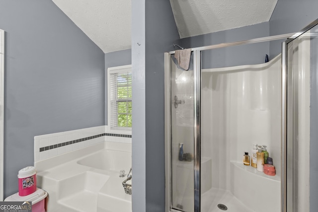 bathroom with a textured ceiling and plus walk in shower