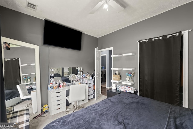 carpeted bedroom featuring ceiling fan and a textured ceiling