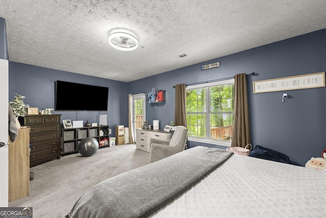 bedroom featuring carpet and a textured ceiling